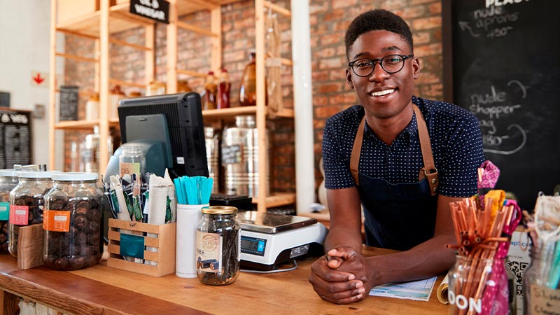 Smiling men at his natural store